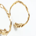 Macro detalle del diseño en espiga de los aros Candonga Espiga dorados, mostrando textura artesanal y acabado en dorado.