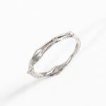 Vista diagonal del Anillo Nido en plata esterlina con diamante de laboratorio, resaltando su textura artesanal.